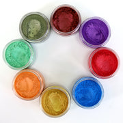 Assorted colorful  8 colors seisso mica powder powders in small jars on a white background